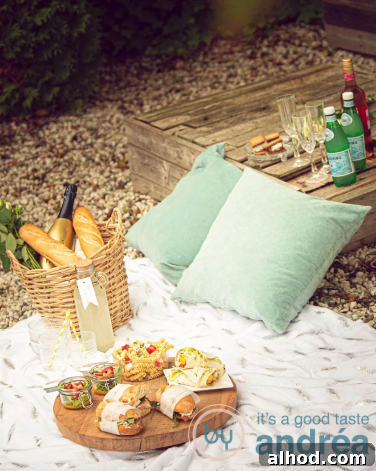 6 Irresistible Picnic Dishes for Your Ultimate Outdoor Gathering 2 A beautiful spread of delicious homemade picnic treats on a classic plaid blanket outdoors, featuring a variety of sandwiches, drinks, and desserts perfect for summer.