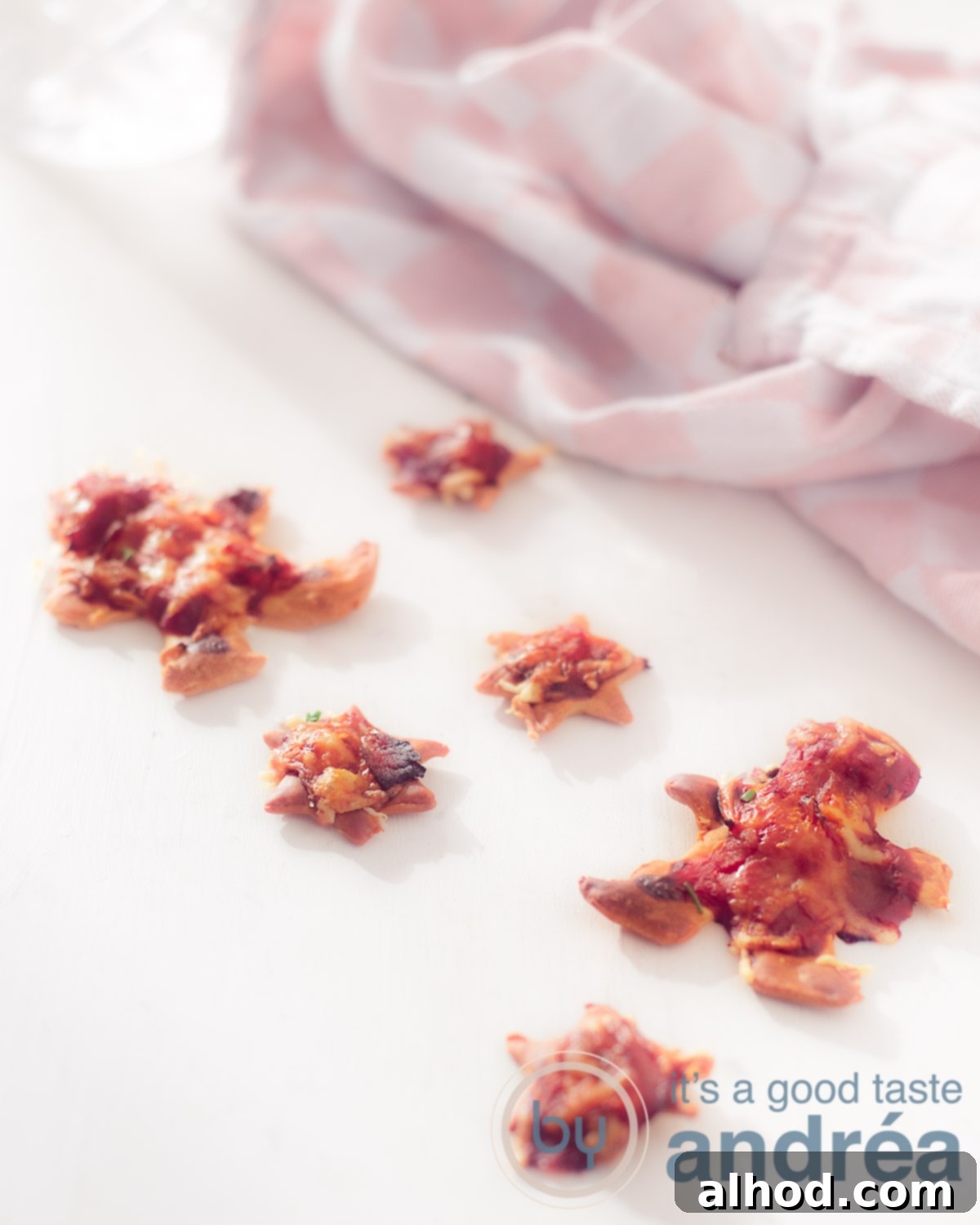 Festive Pizza Bites 5 six mini pizza's on a white background with a pink white cloth