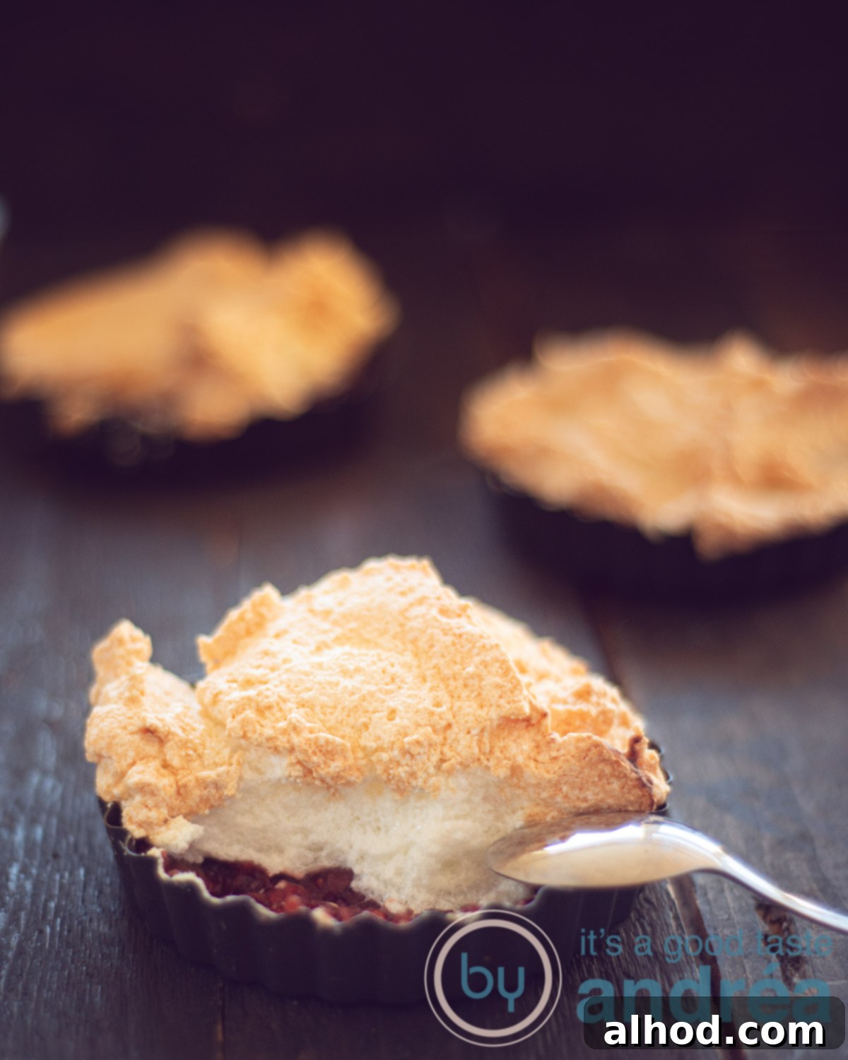 Rhubarb Custard Meringue Cloud 2 Three quiche forms filled with sweet rhubarb stew and topped with a caramelized foam.