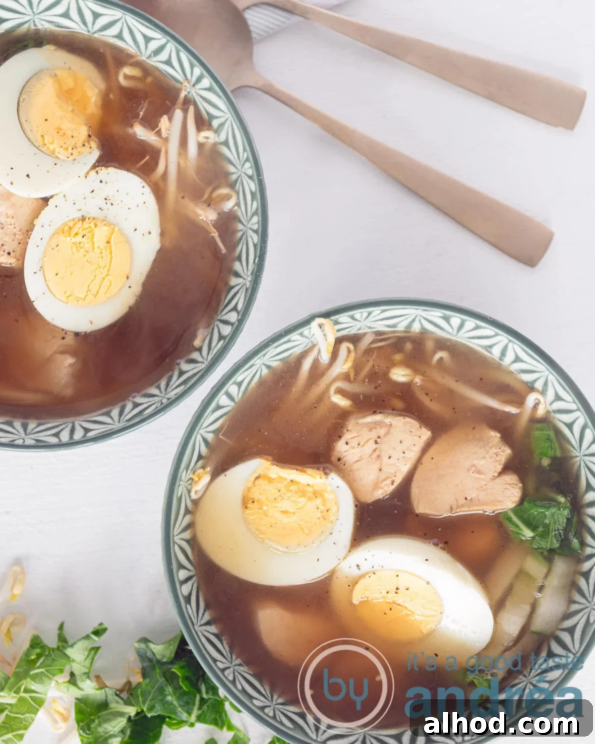 Making Japanese Chicken Ramen at Home 2 A beautiful white bowl filled with steaming Homemade Japanese Chicken Ramen Noodle soup, garnished with a perfectly cooked egg, fresh green onions, and vibrant vegetables, ready to be enjoyed.