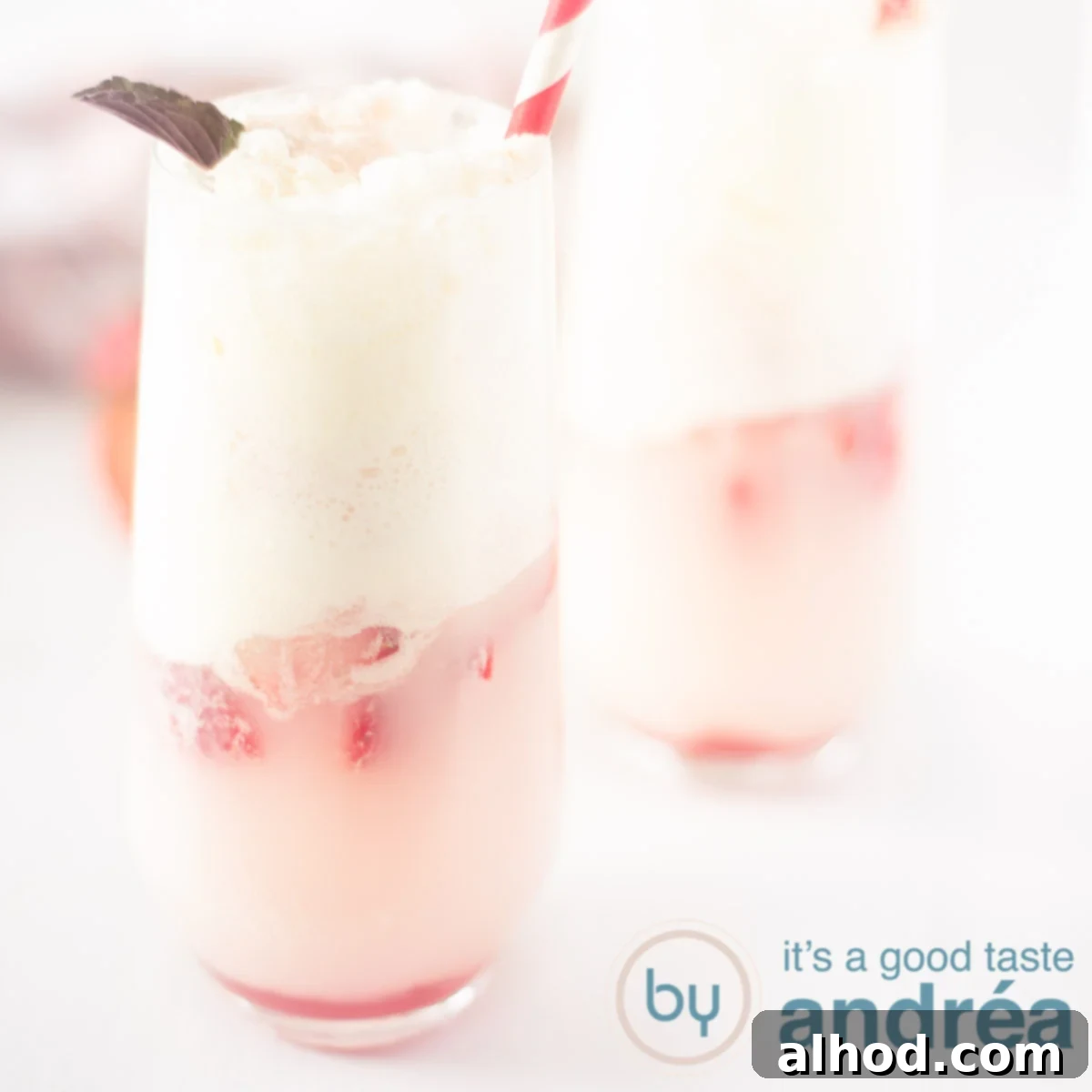 Strawberry Soda Float 6 A square photo with two glasses of soda ice cream with strawberries on a white background, highlighting the final delicious product.