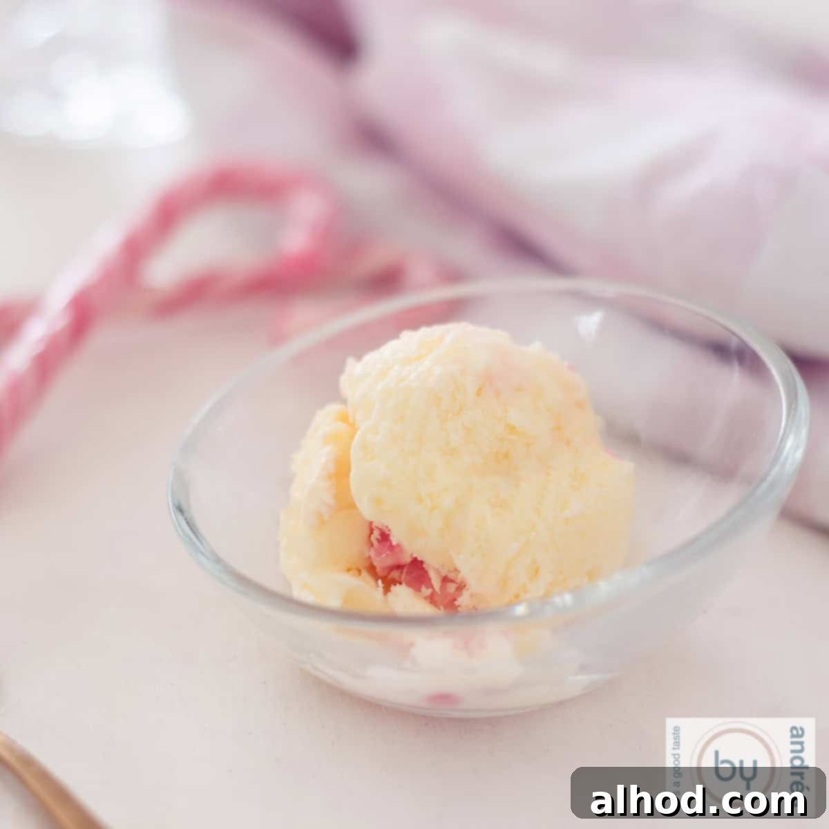 Christmas Dessert Extravaganza 3 A glass bowl with a ball of candy cane ice cream. Some candy canes in the back