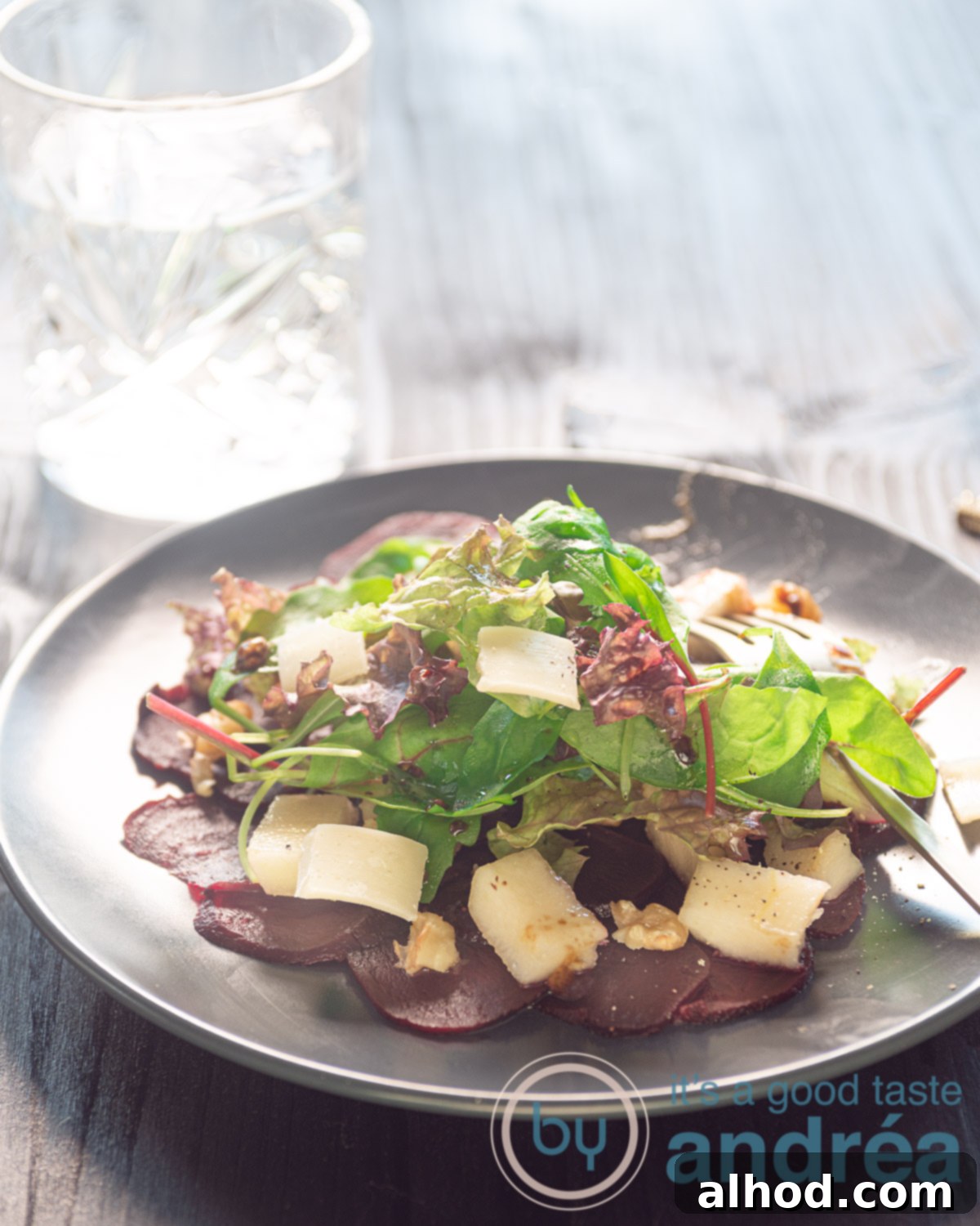 Vibrant beet carpaccio with fresh toppings, a perfect vegetarian appetizer