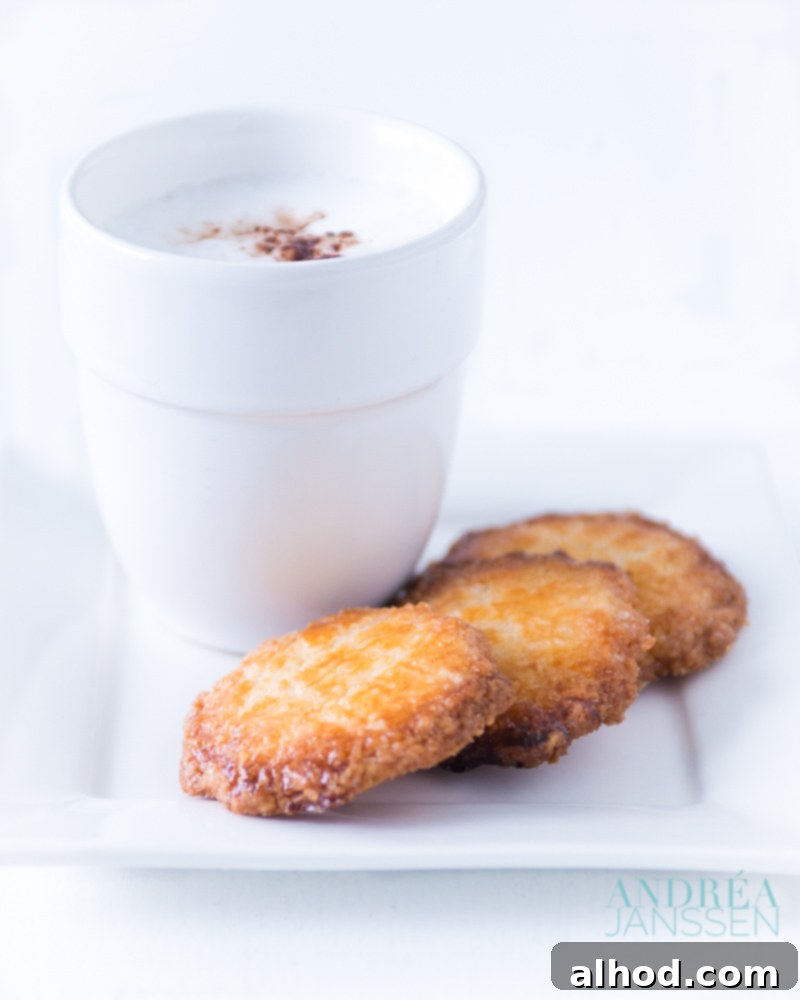 Perfectly golden-brown salted butter cookies, artfully arranged and served alongside a refreshing glass of milk, a timeless and comforting combination.