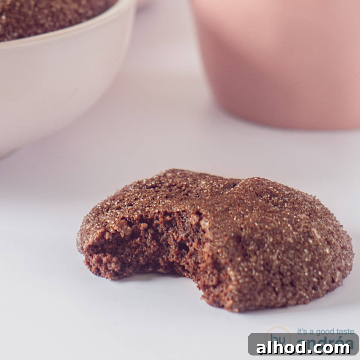 A captivating square photo featuring a freshly baked chocolate chip cookie with a delicious bite taken out, set against a pristine white background, inviting immediate indulgence.