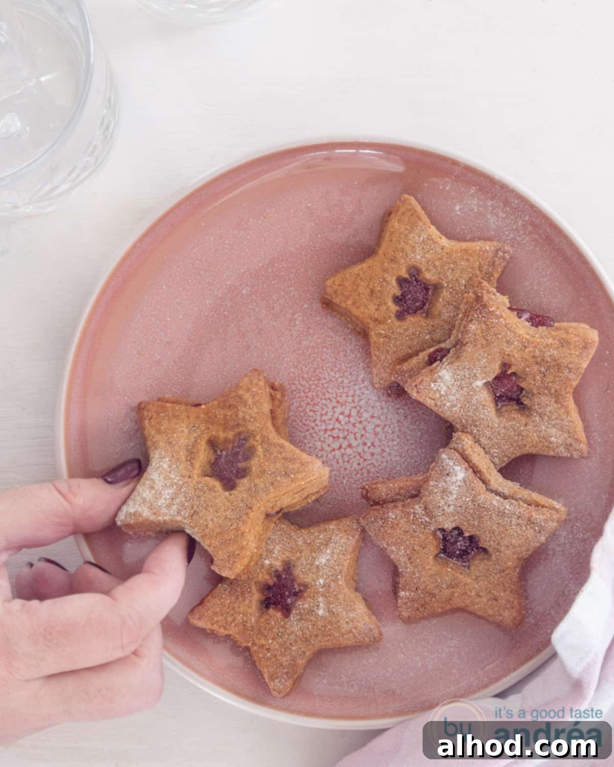 Festive Christmas jelly cookies, beautifully adorned with warm winter spices and vibrant jam centers, perfect for holiday celebrations and gifting.