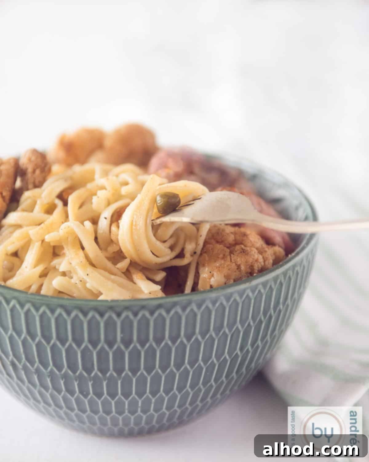 Hearty Beef and Cauliflower Noodle Bowl 2 Delicious stir-fry with cauliflower, noodles, and strips of beef, ready to be served.