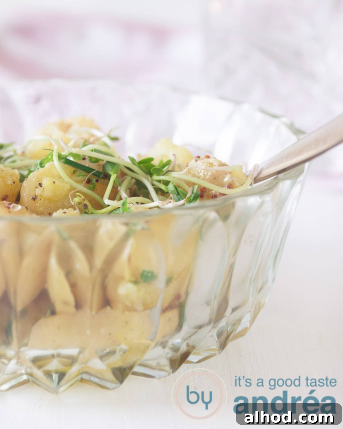 Velvety Baby Dutch Potato Salad 2 Half a glass bowl filled with new potatoes served as a salad. A white backdrop.