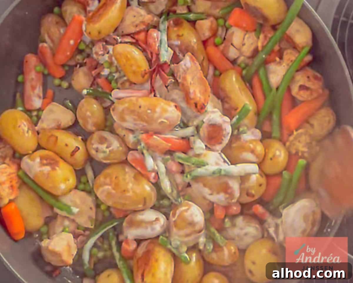 Golden Skillet Chicken with Crispy Bacon and Potatoes 6 The finished Chicken Potato Skillet with a creamy Dijon sauce coating all the ingredients, ready to be garnished with fresh parsley.