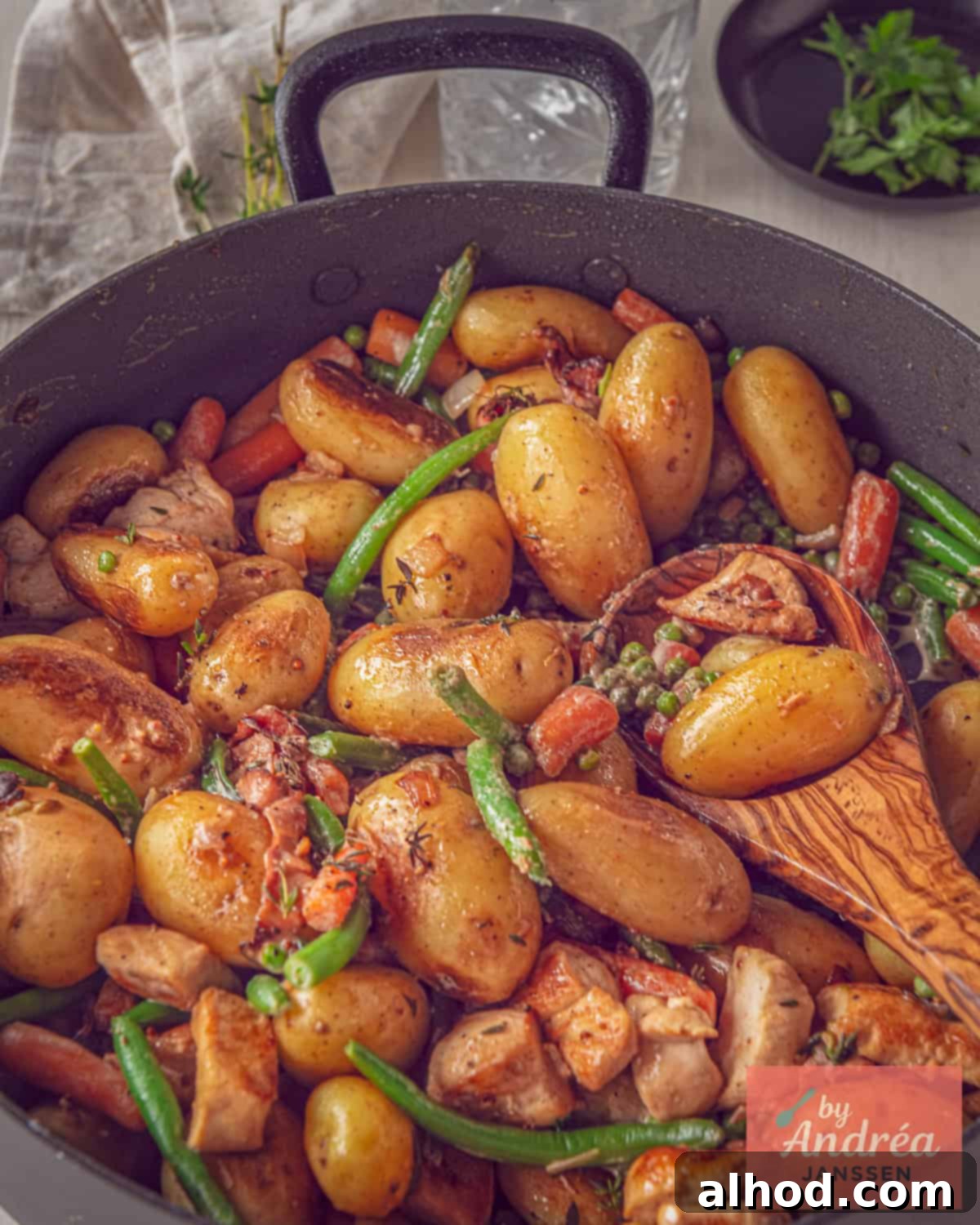 Golden Skillet Chicken with Crispy Bacon and Potatoes 7 A beautiful top-down photo showcasing a complete pan of the Bonne Femme skillet with chicken, baby potatoes, crispy bacon, and colorful vegetables, bathed in a creamy sauce, ready to be served.