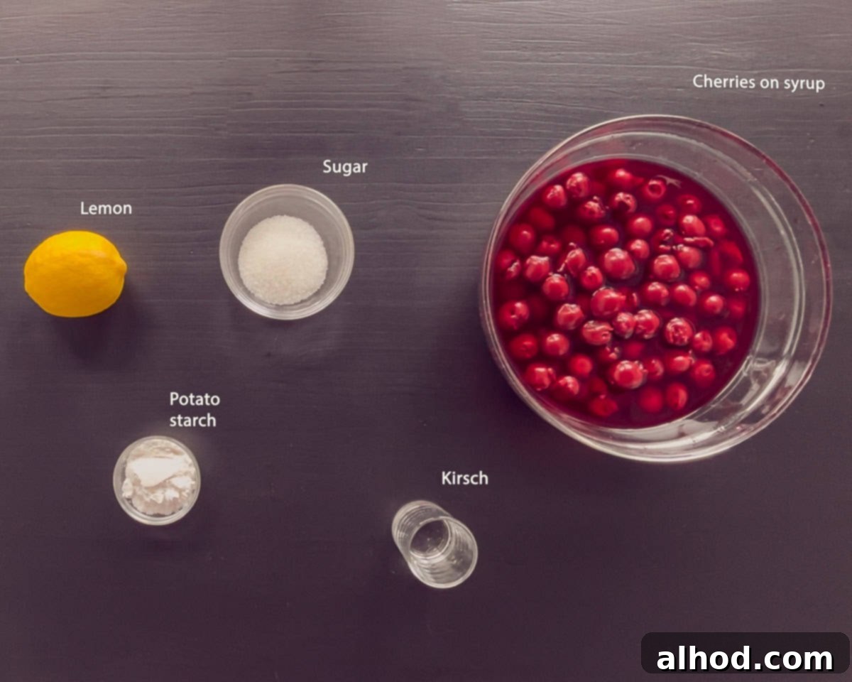 Various ingredients for Dutch Kersenvlaaivulling cherry pie filling, including a jar of cherries, sugar, a lemon, and potato starch, arranged on a black background.