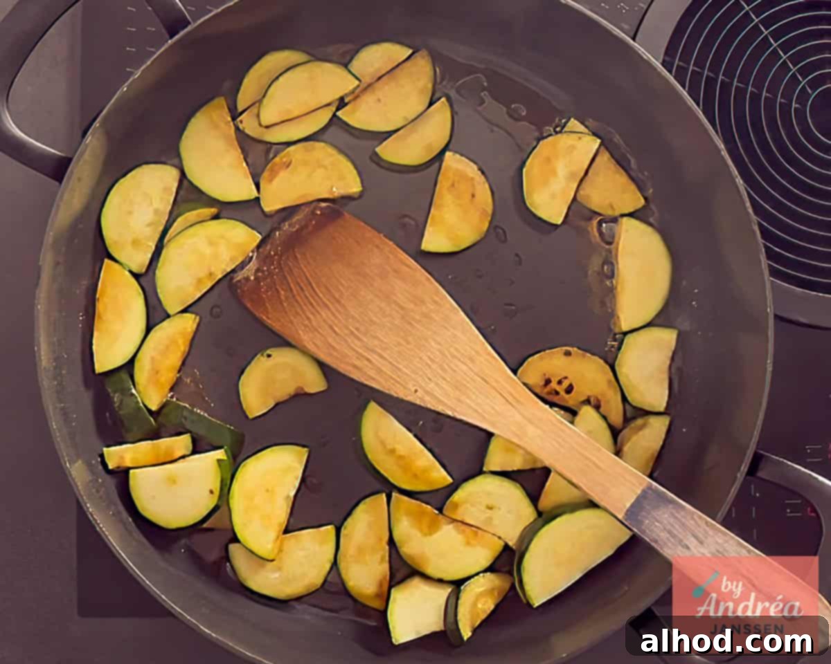 Frying zucchini slices in a frying pan