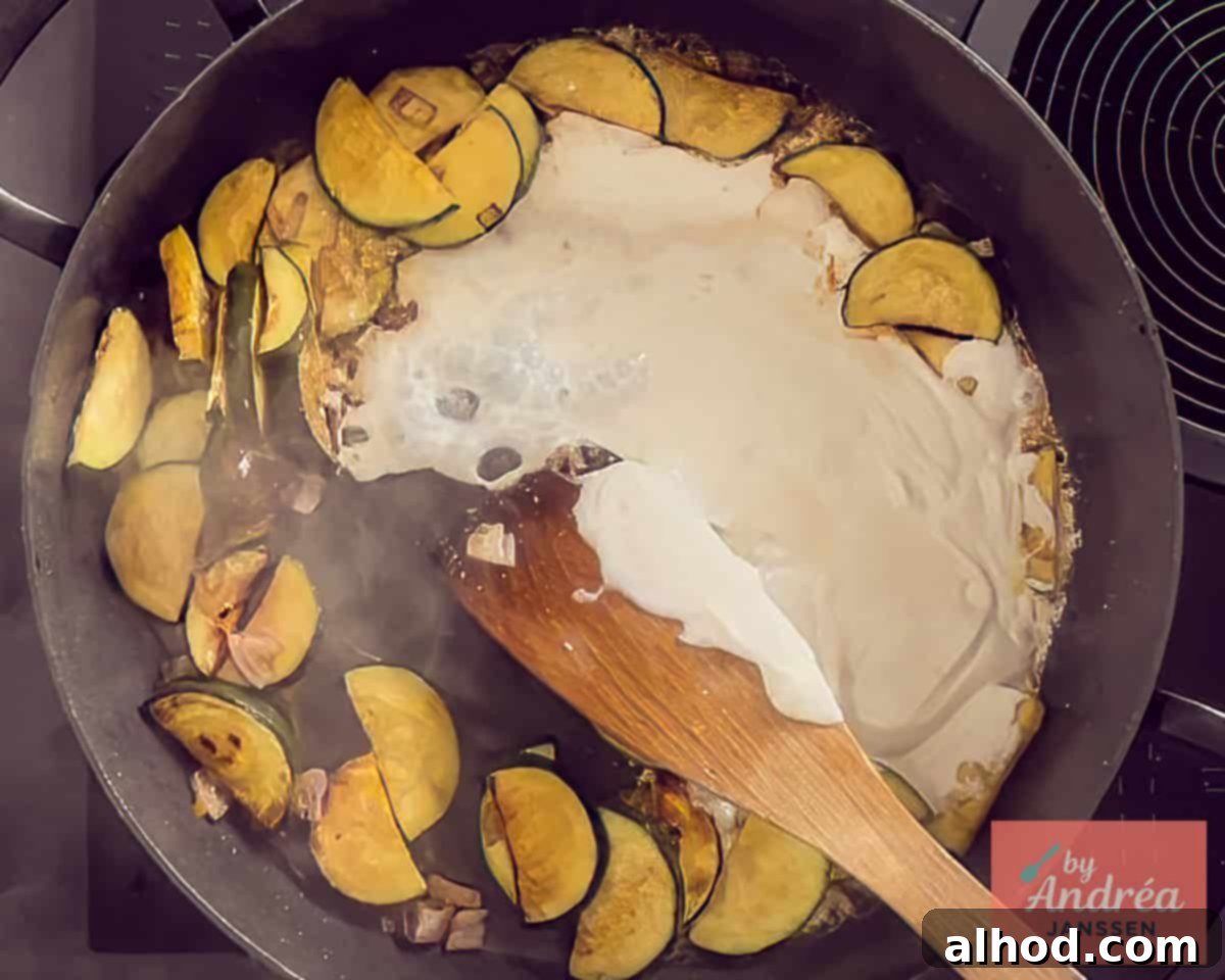 Cream and seasonings are added to the zucchini frying pan
