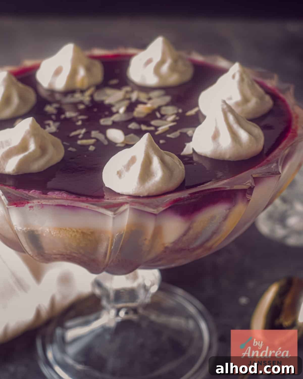 A trifle dish with trifle with red fruit, custard and sherry.