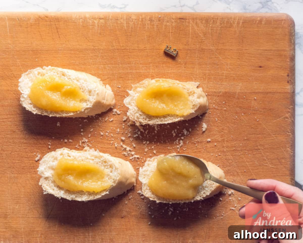 Applesauce is spread on slices of baguette