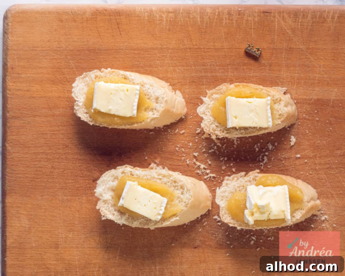 Brie is placed on slices of baguette with apple sauce