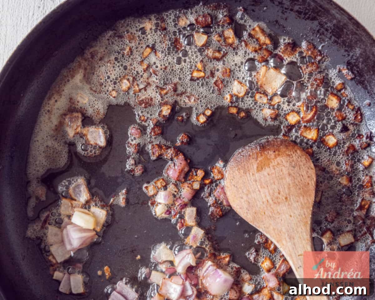 Onion is fried in the frying pan