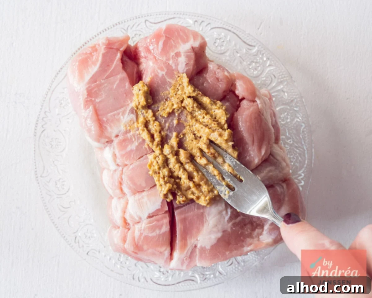 Rolled meat is rubbed with garlic mustard marinade