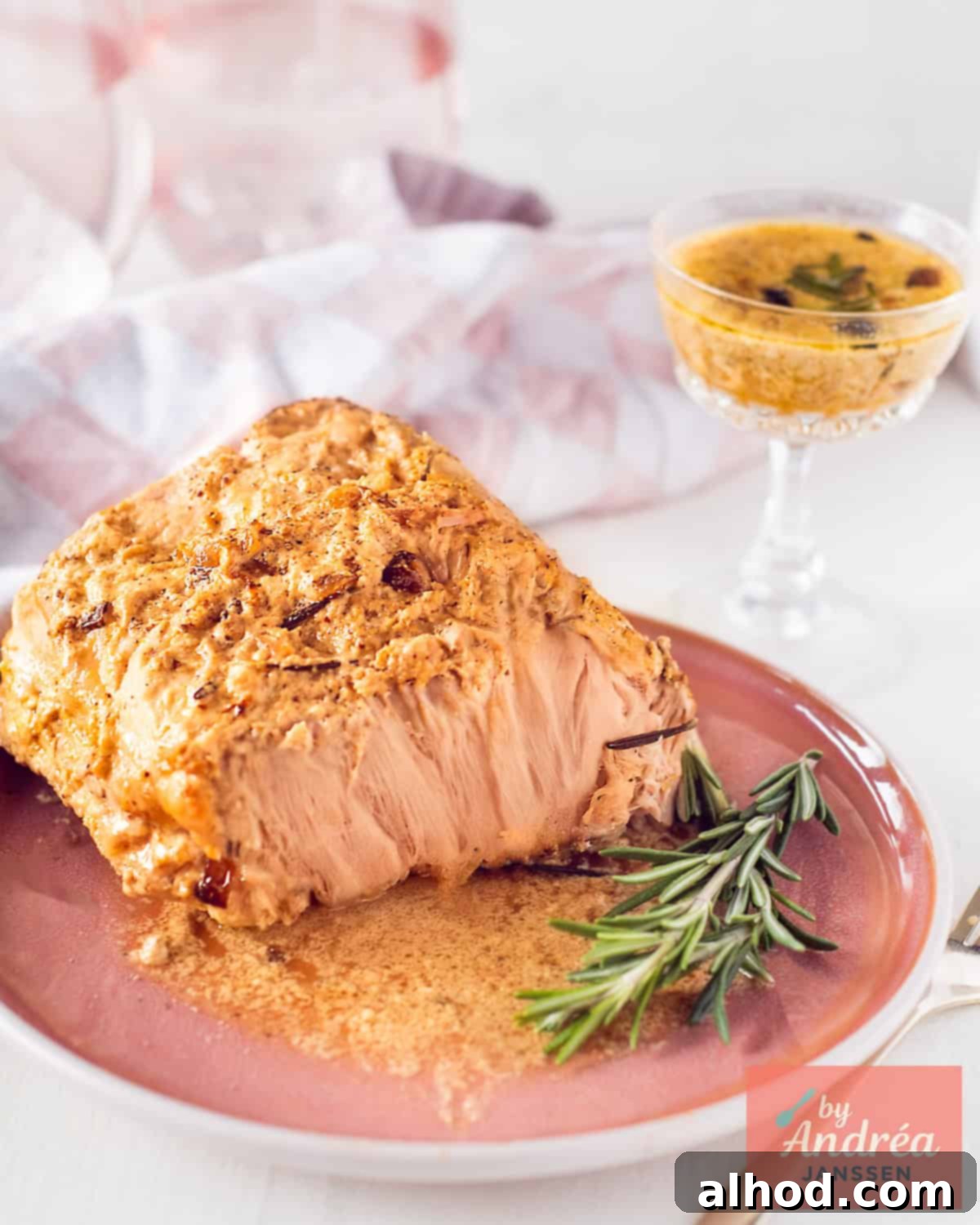 Slow cooker pork rollade with creamy onion sauce sliced on a serving platter