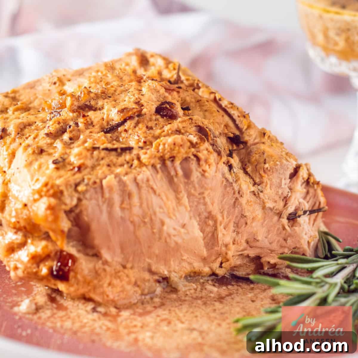 Slow cooker pork rollade served on a pink plate