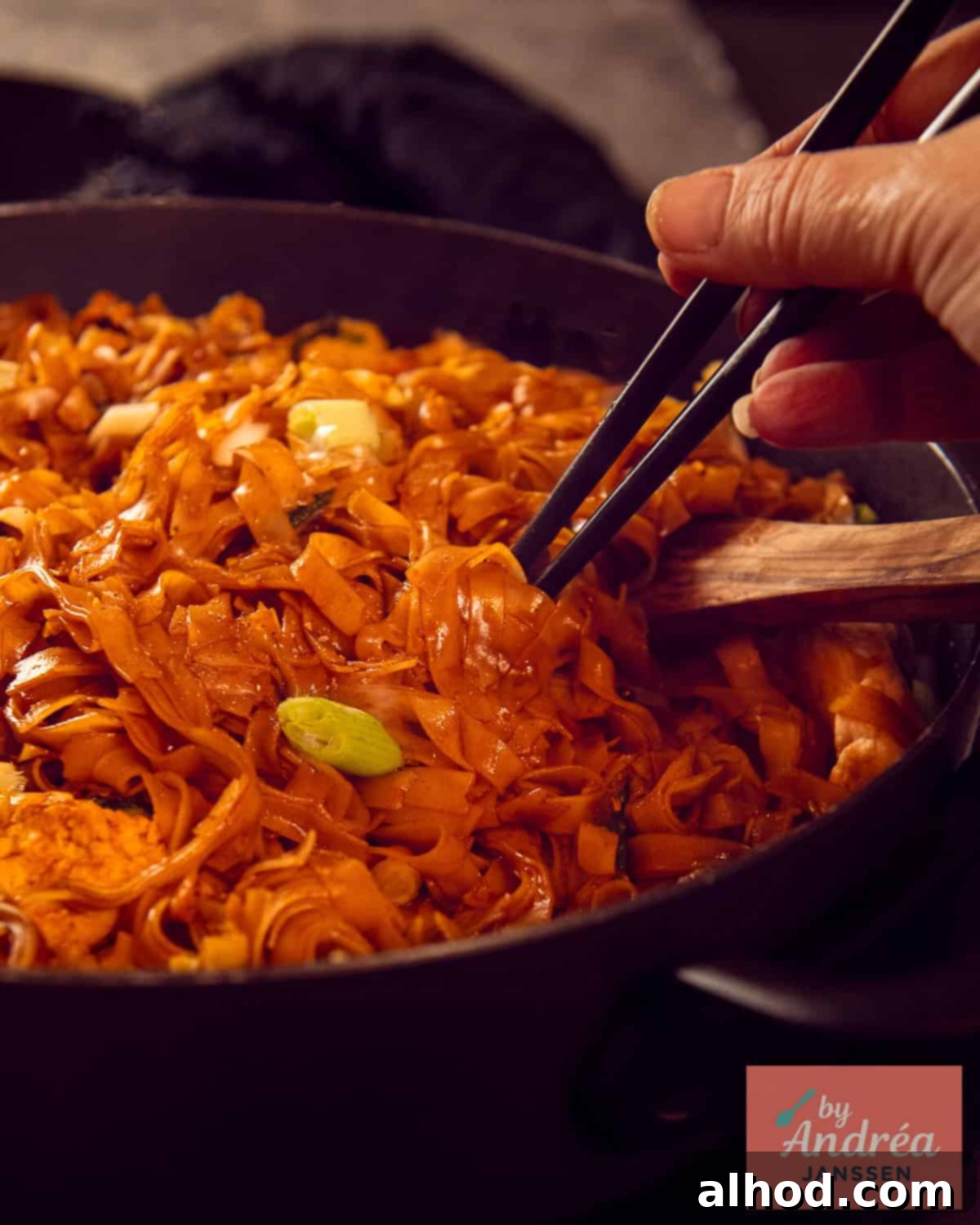 Quick Chicken Pad See Ew: 20-Minute Thai Noodle Perfection 10 A close-up shot of a pan filled with perfectly caramelized Chicken Pad See Ew noodles with chicken and egg.