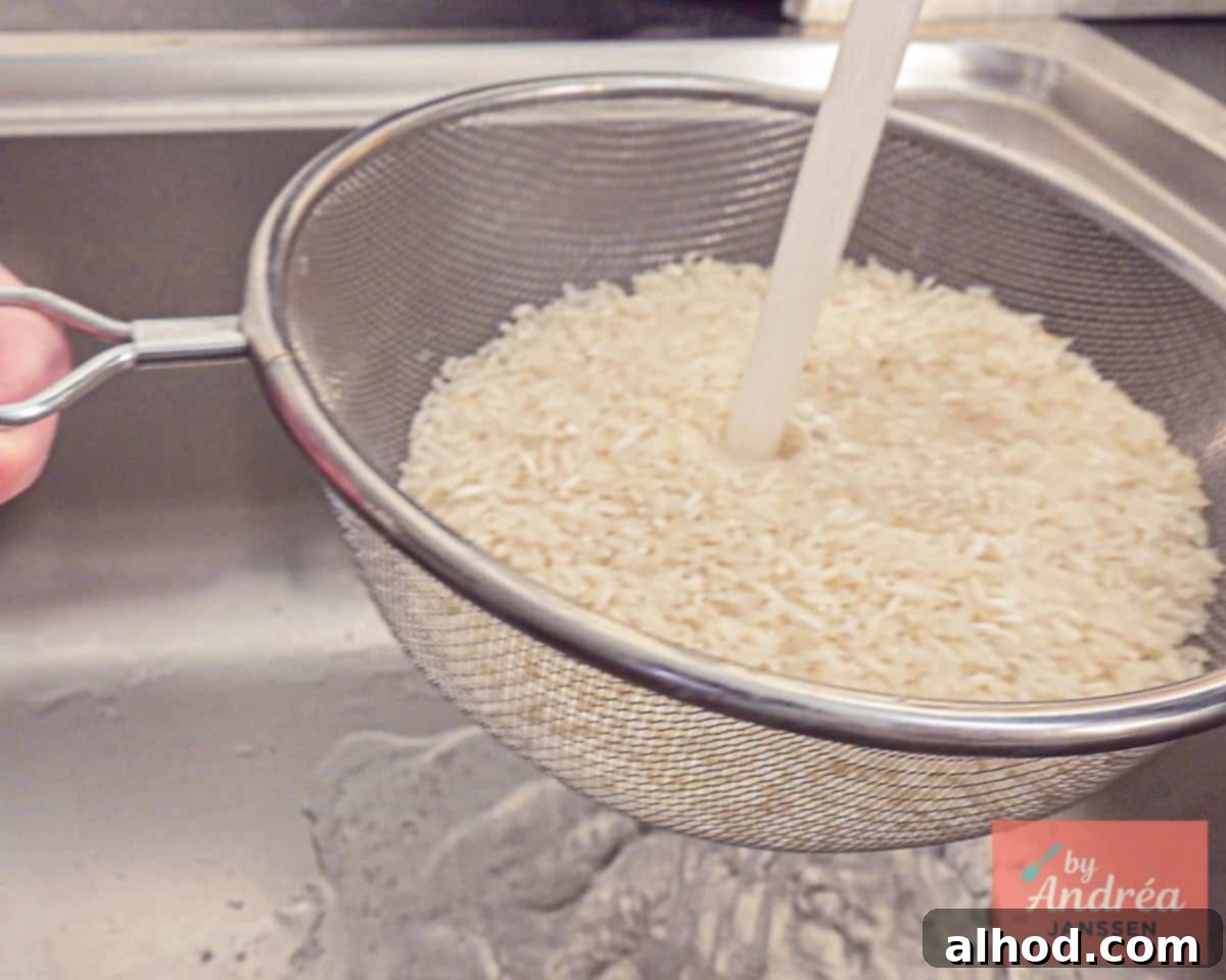 30-Minute Fiesta Rice 4 Long grain rice is rinsed under the tap.