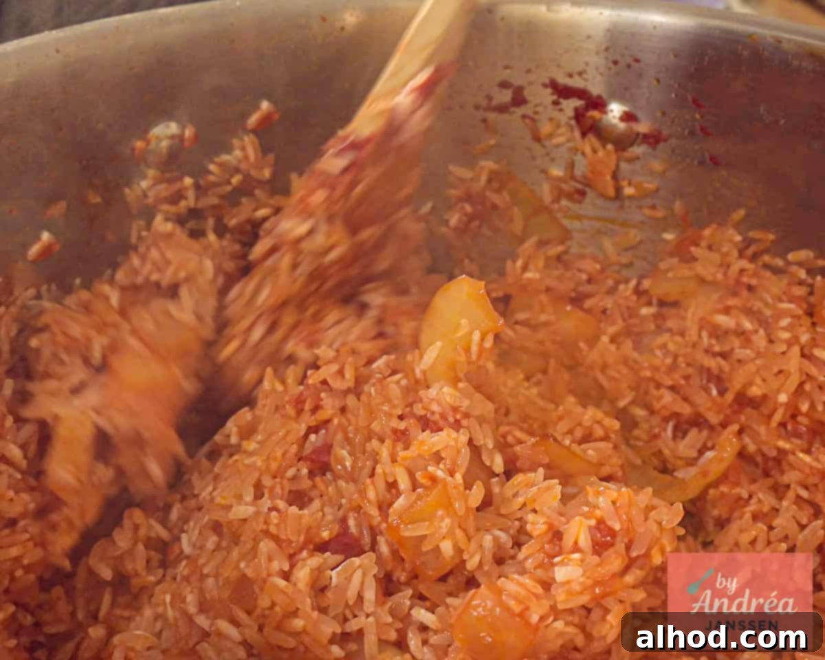 30-Minute Fiesta Rice 6 Fry rice in seasonings in the pan.