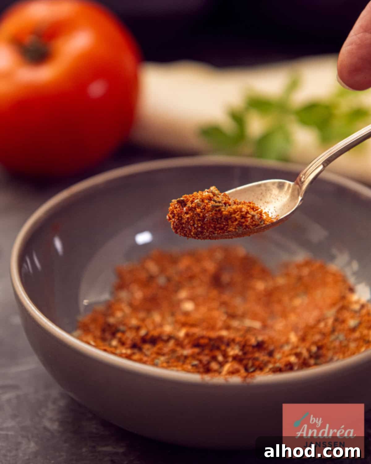 Burrito Seasoning Blend for Beef 2 A spoon showcasing the vibrant spices of the homemade burrito seasoning mix.