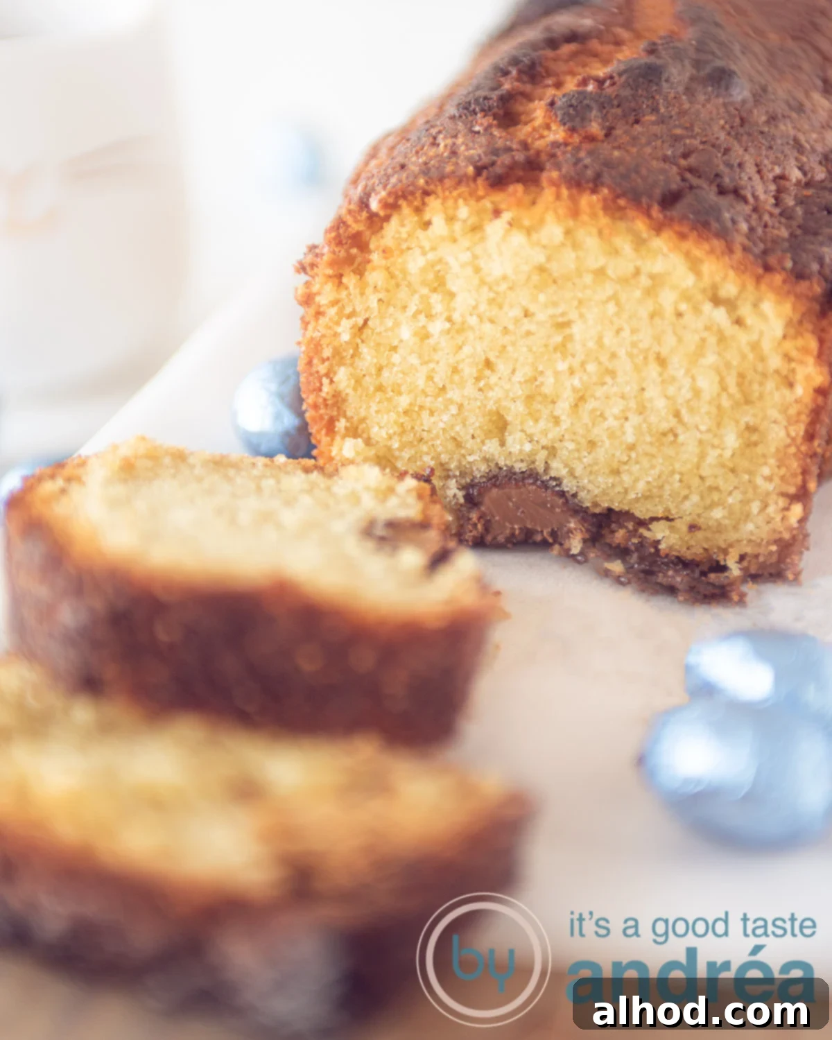 A slice of Easter Pound Cake filled with chocolate eggs, served with a cup of coffee.